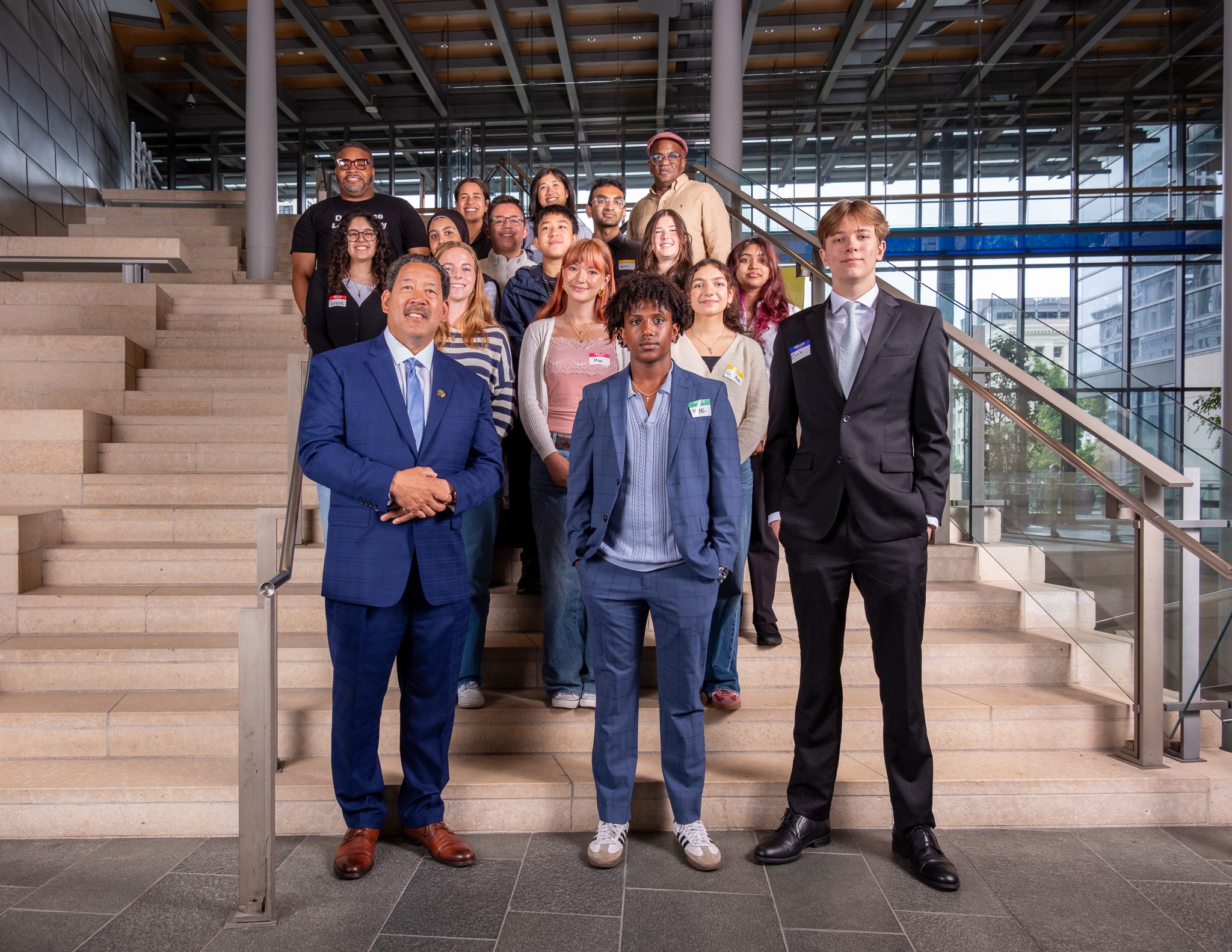 Mayor Bruce Harrell, Seattle Office for Civil Rights Director, Derrick Wheeler-Smith, SOCR Policy staff, and YCEP participants stand on City Hall steps