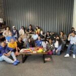 A group of about 20 people smiling