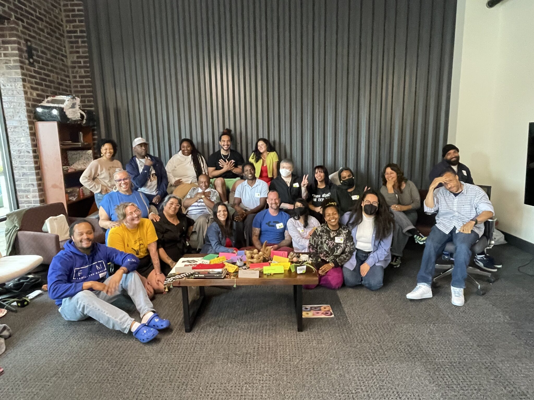 A group of about 20 people smiling